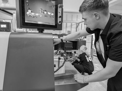 Press operator checking colour on the control panel