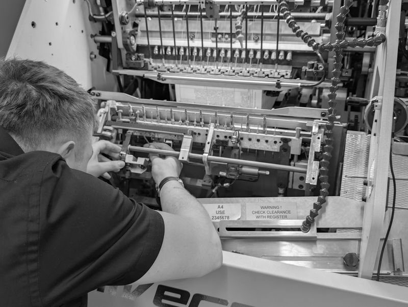 Hardback books being thread-sewn on the Universe sheet-fed sewing machine at our Exeter facility