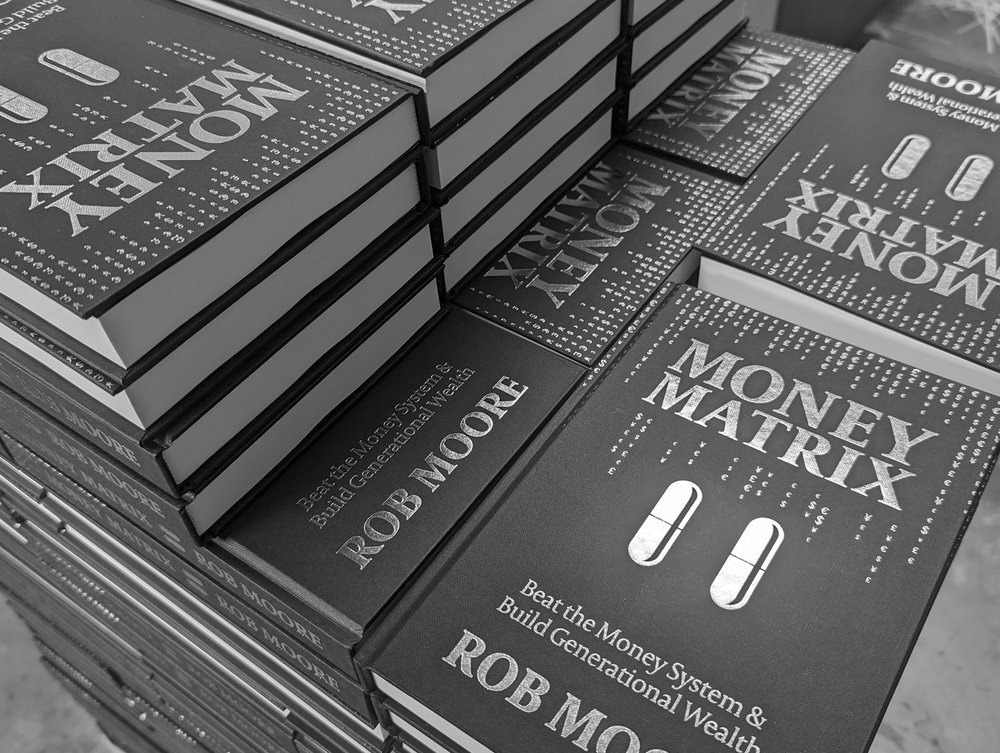 Stacks of finished hardback books, silver-foil-blocked covers, produced at our Exeter facility