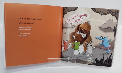 A bilingual picture book open to an illustrated spread