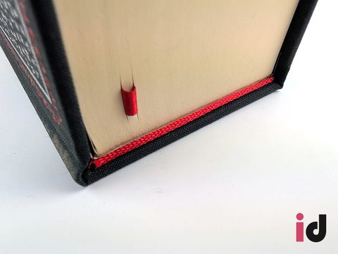Red ribbon marker and head band on a black cloth hardback