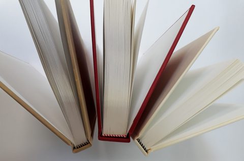 Head bands on three hardbacks standing open