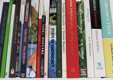 Customers' paperbacks on a shelf in a range of sizes