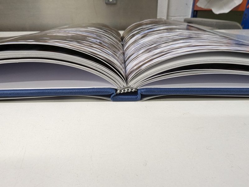 A cloth-cased photobook lying open flat