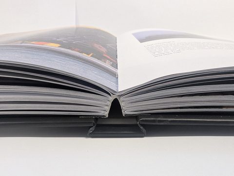 A sewn hardback lying open flat on the bench